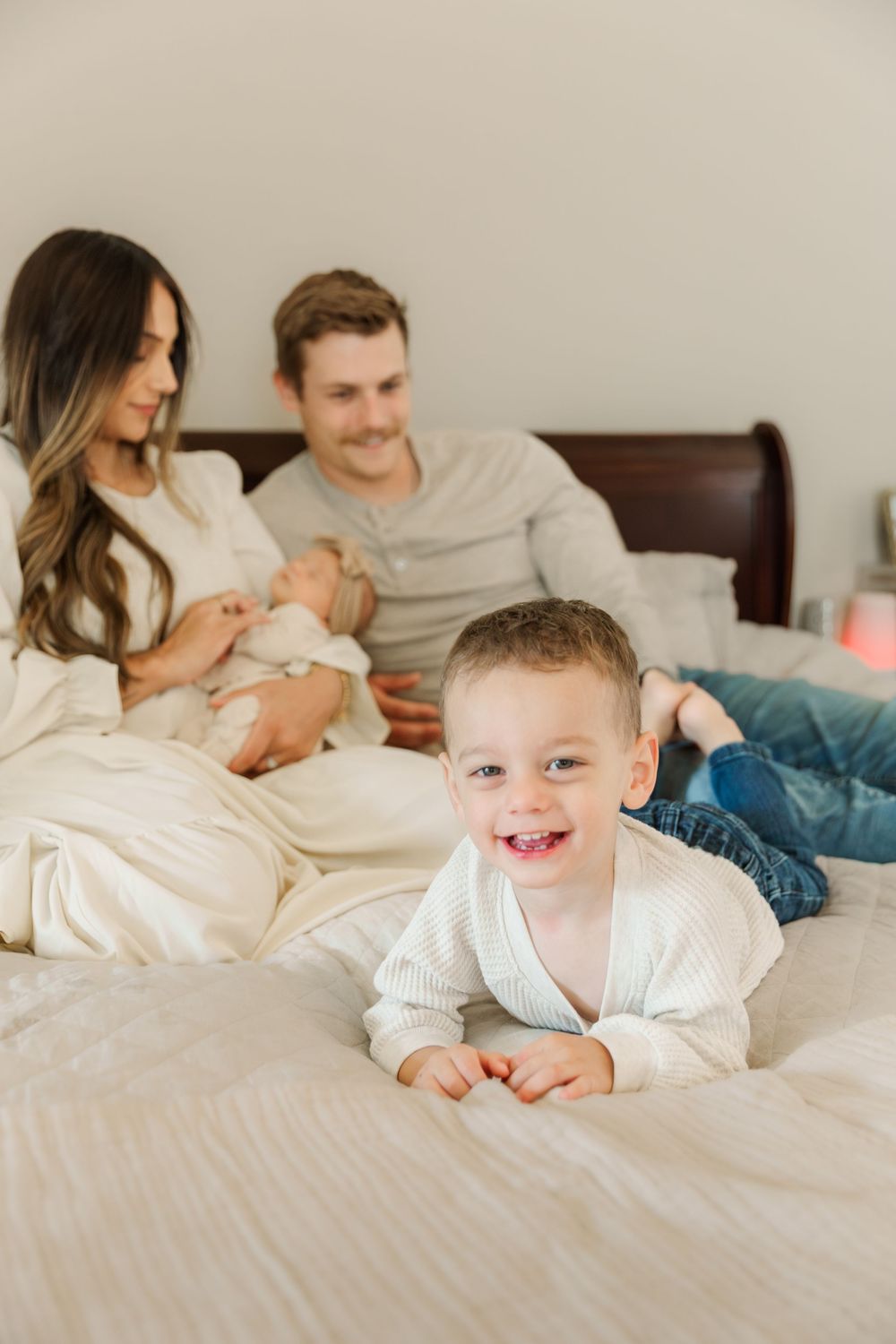 Candid lifestyle photos of family playtime and bonding on white bedding.