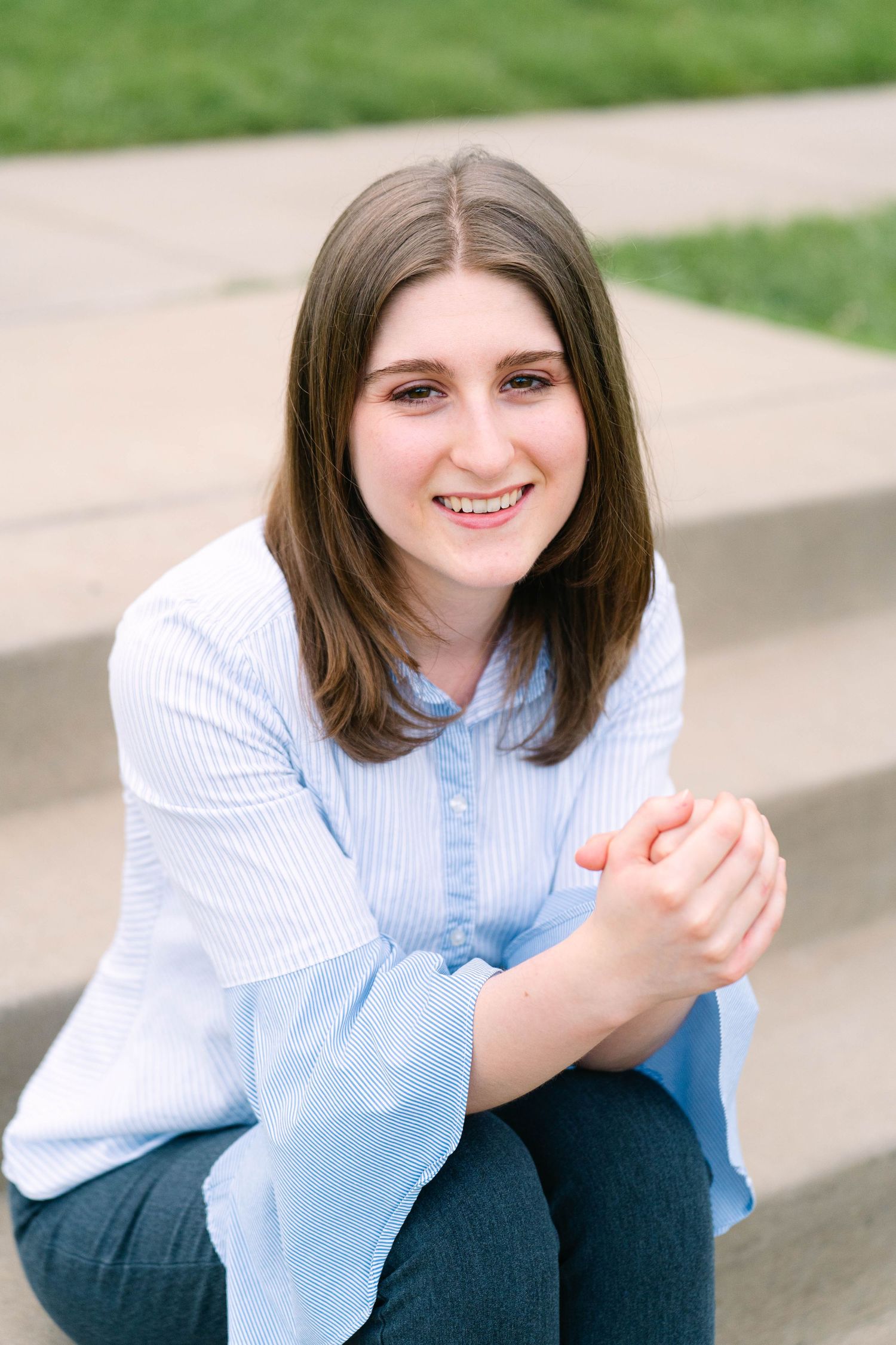 Warm, glowing golden hour headshot of a young woman surrounded by nature in Stillwater, Minnesota