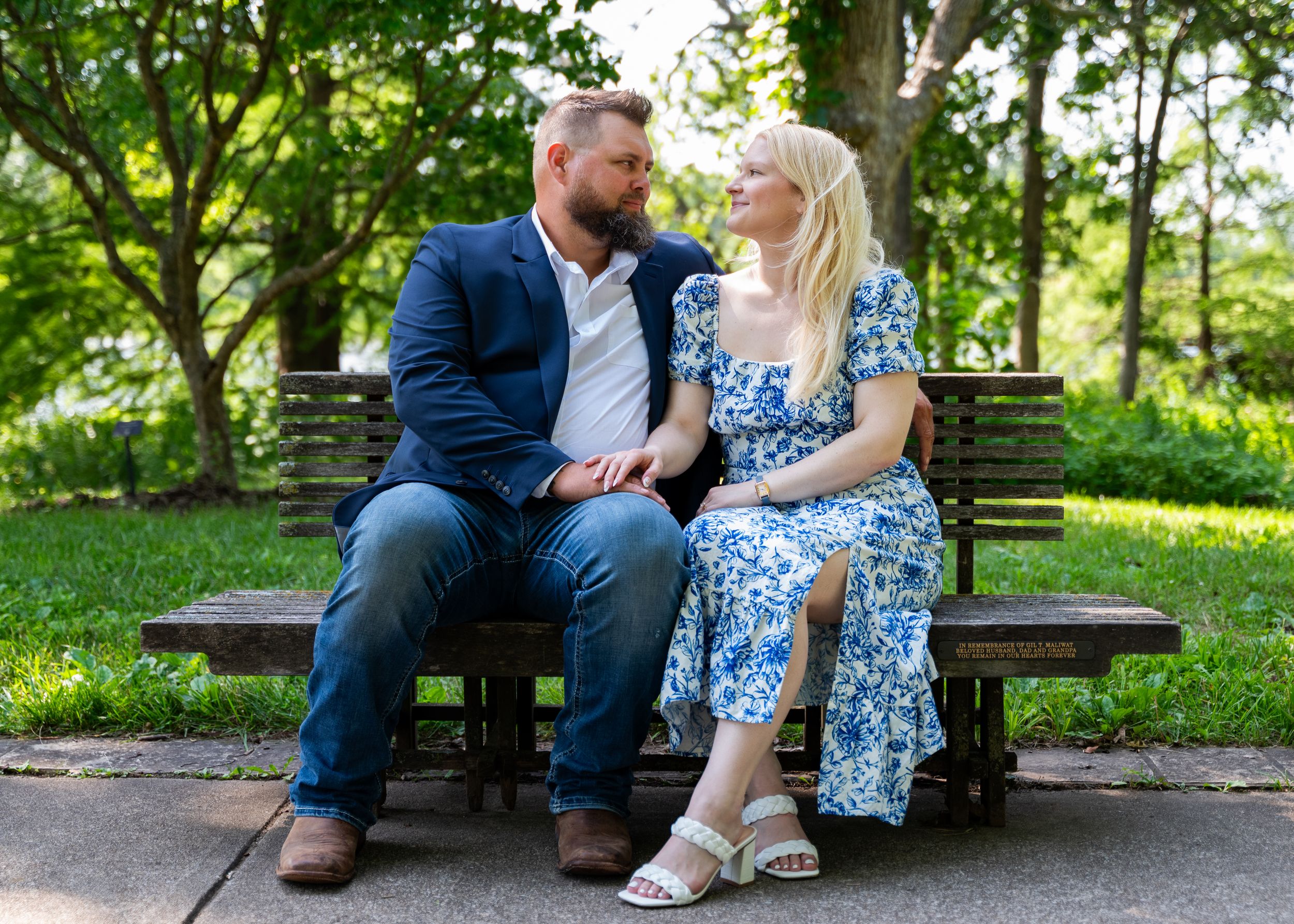 formal outfit wearing couple sitting on bench near a pathway in powell gardens kansas city missouri
