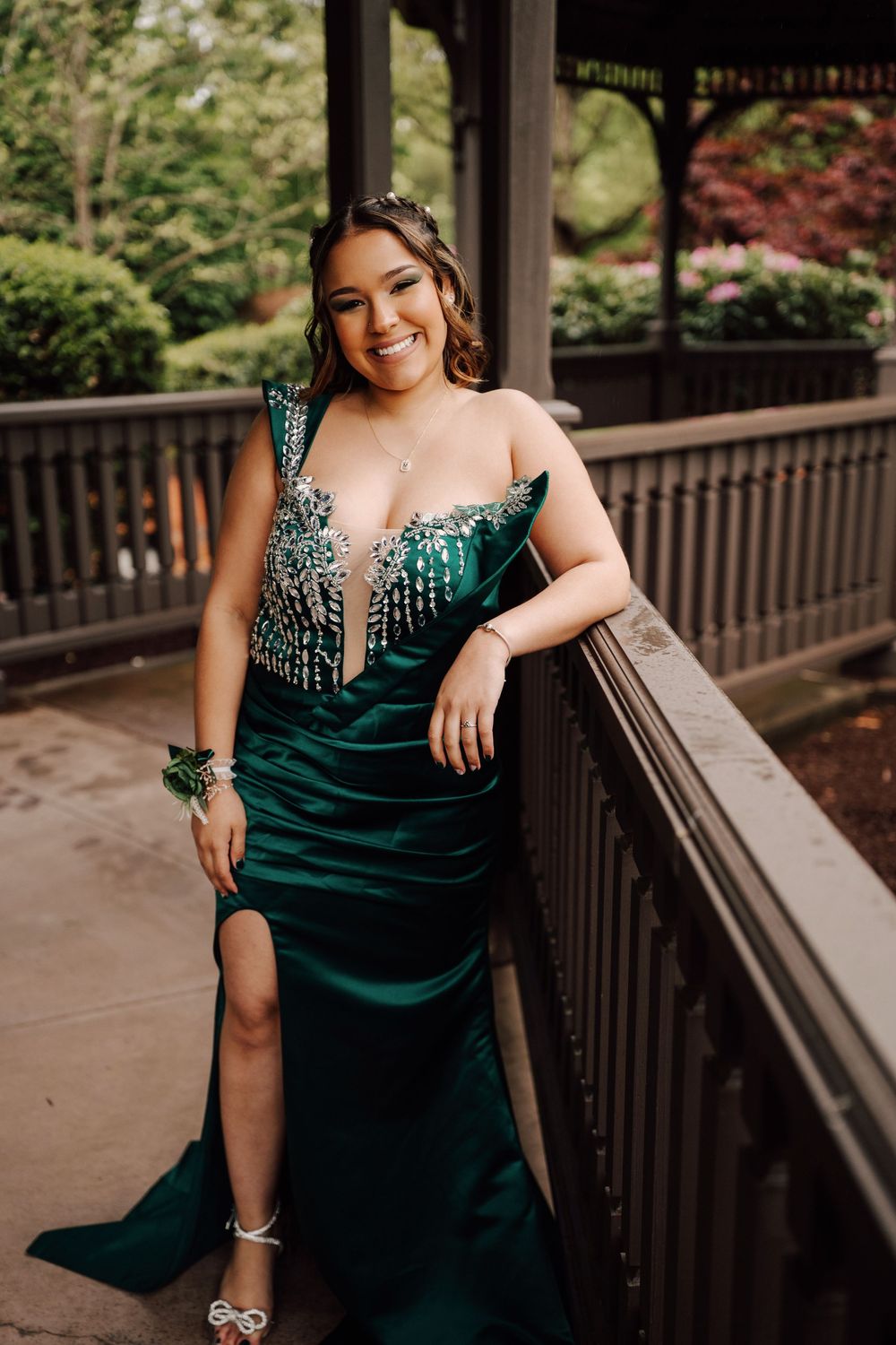 High school senior posing in elegant emerald green formal gown for prom photoshoot at Hershey, PA.