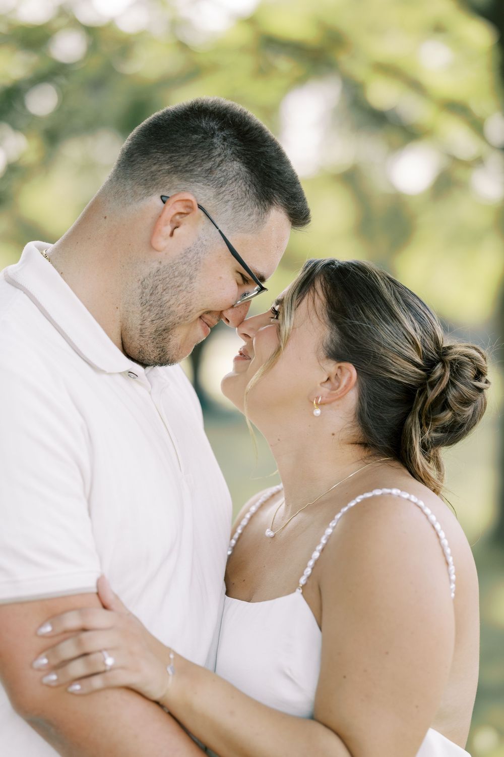 A romantic wedding couple shares intimate moments in a series of outdoor portraits with soft natural lighting.