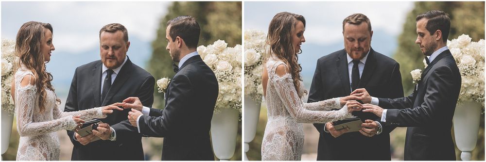 A couple stands together outdoors sharing an intimate moment during a wedding ceremony.