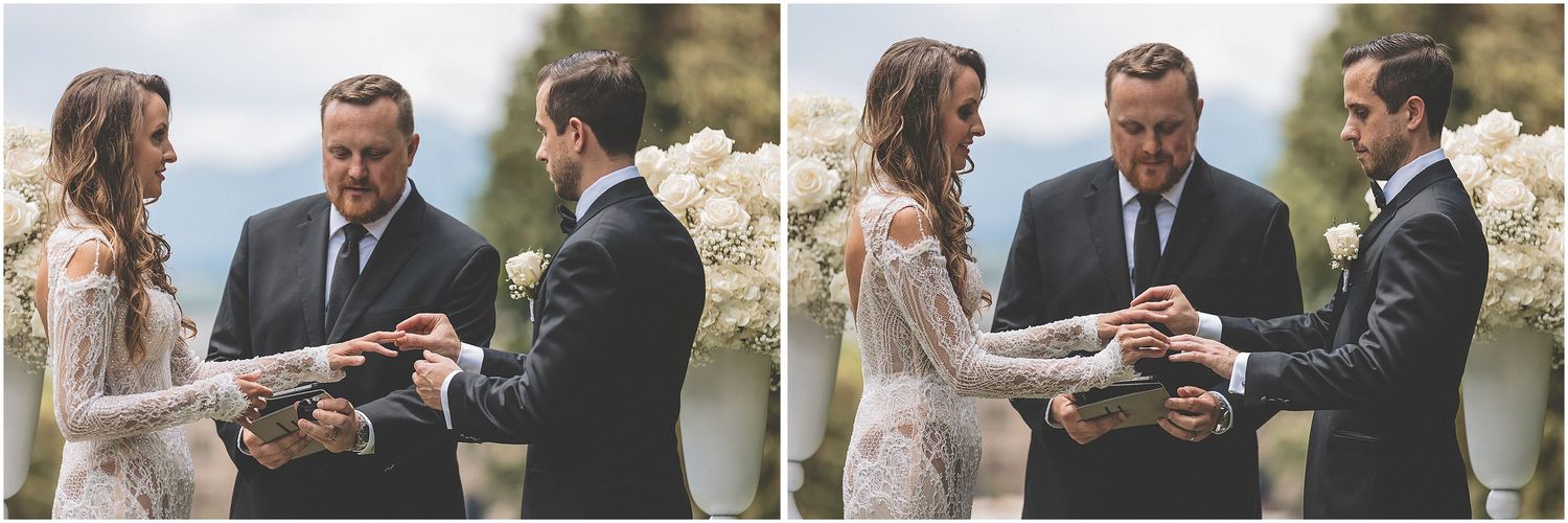 A couple stands together outdoors sharing an intimate moment during a wedding ceremony.