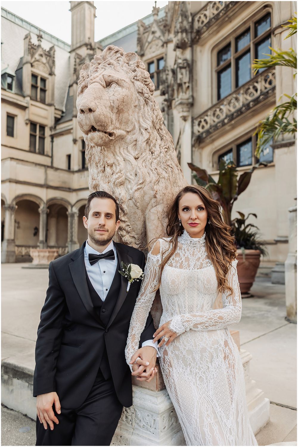 A wedding couple poses together on architectural stone steps of an elegant mansion in a candid movement sequence.