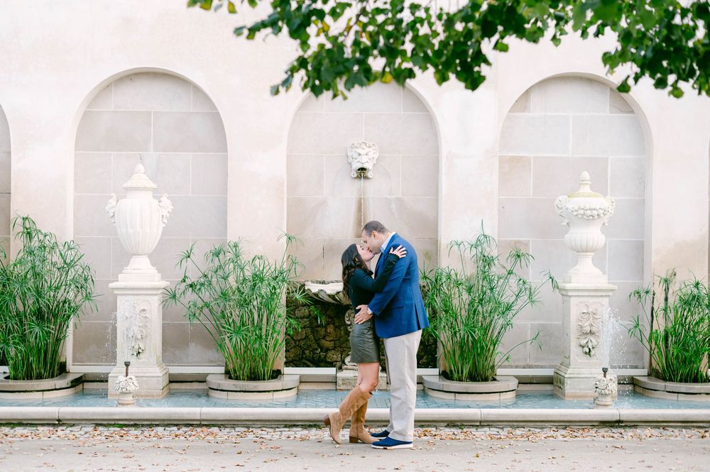 An elegant white stone colonnade with fountains and gardens creates a romantic photography backdrop.