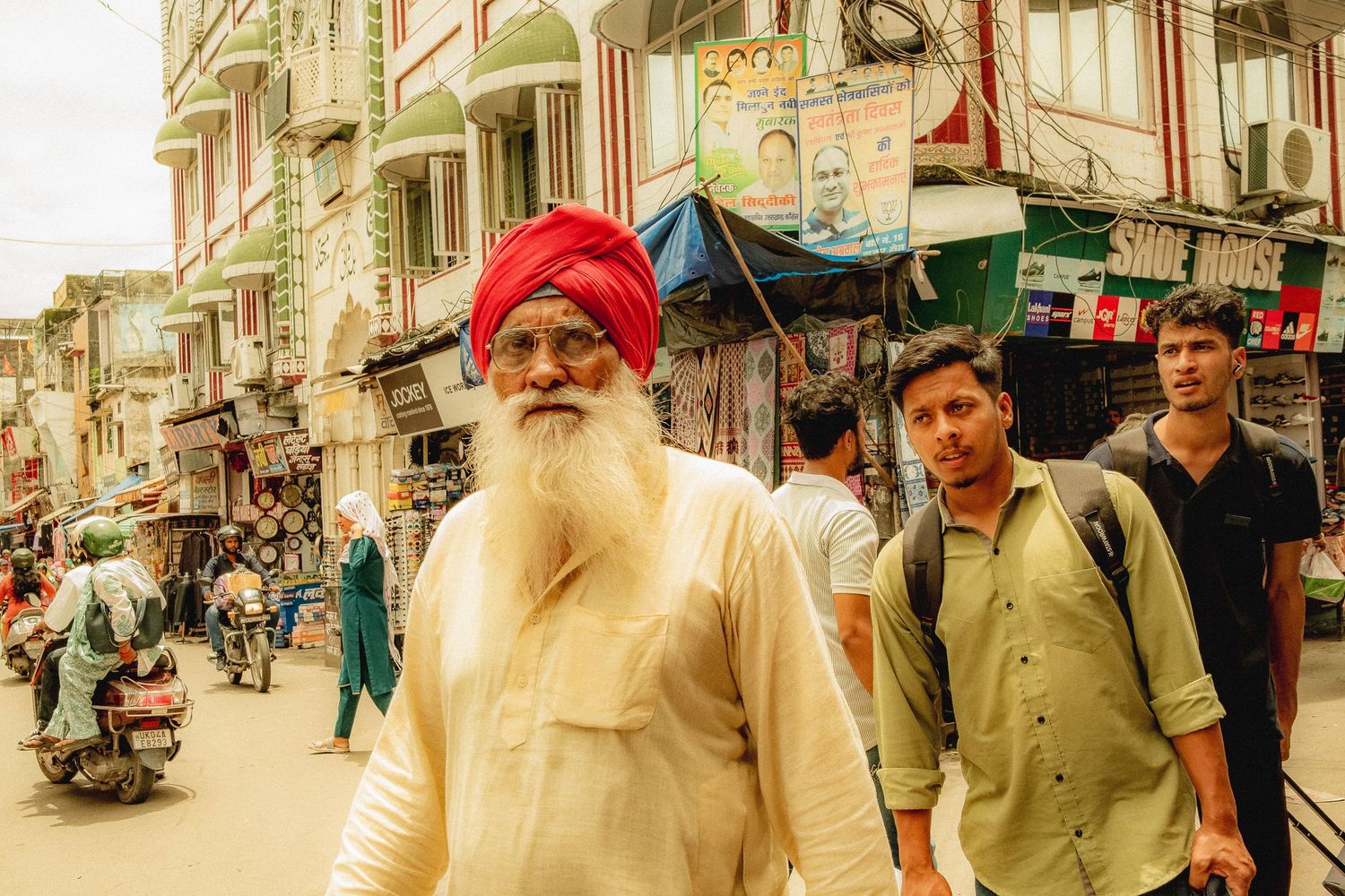 Busy street scene in Nepal with traditional architecture and shops lining the road.