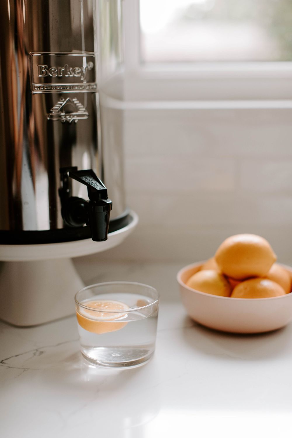 Minimalist kitchen counter with citrus fruits and clear glass containers.
