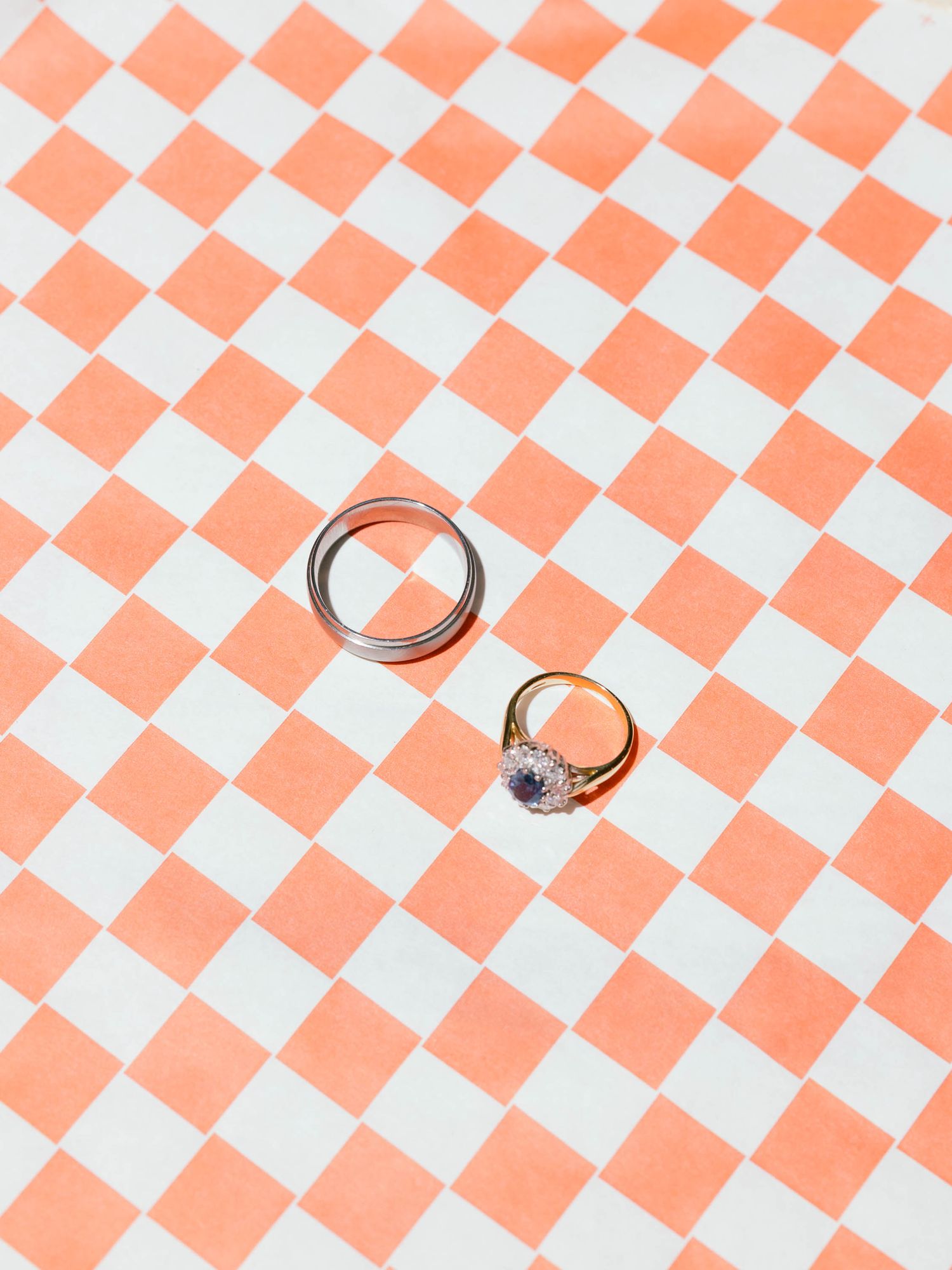 Red and white checkered pattern on a surface with dramatic diagonal lighting.