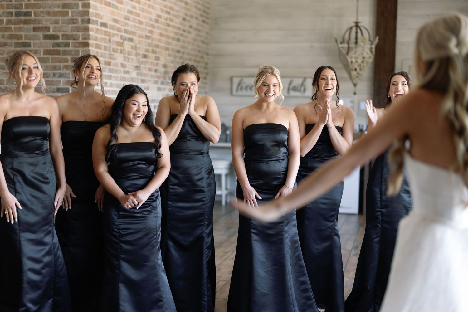 Series of candid shots showing a bridal party in navy dresses and white gown reacting with joy and laughter.