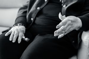 Black and white photo series showing expressive hand gestures against dark background.