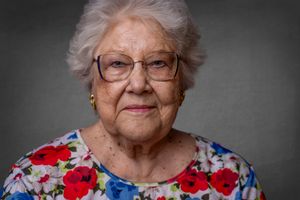 Studio portrait series against grey background showing different expressions and angles.