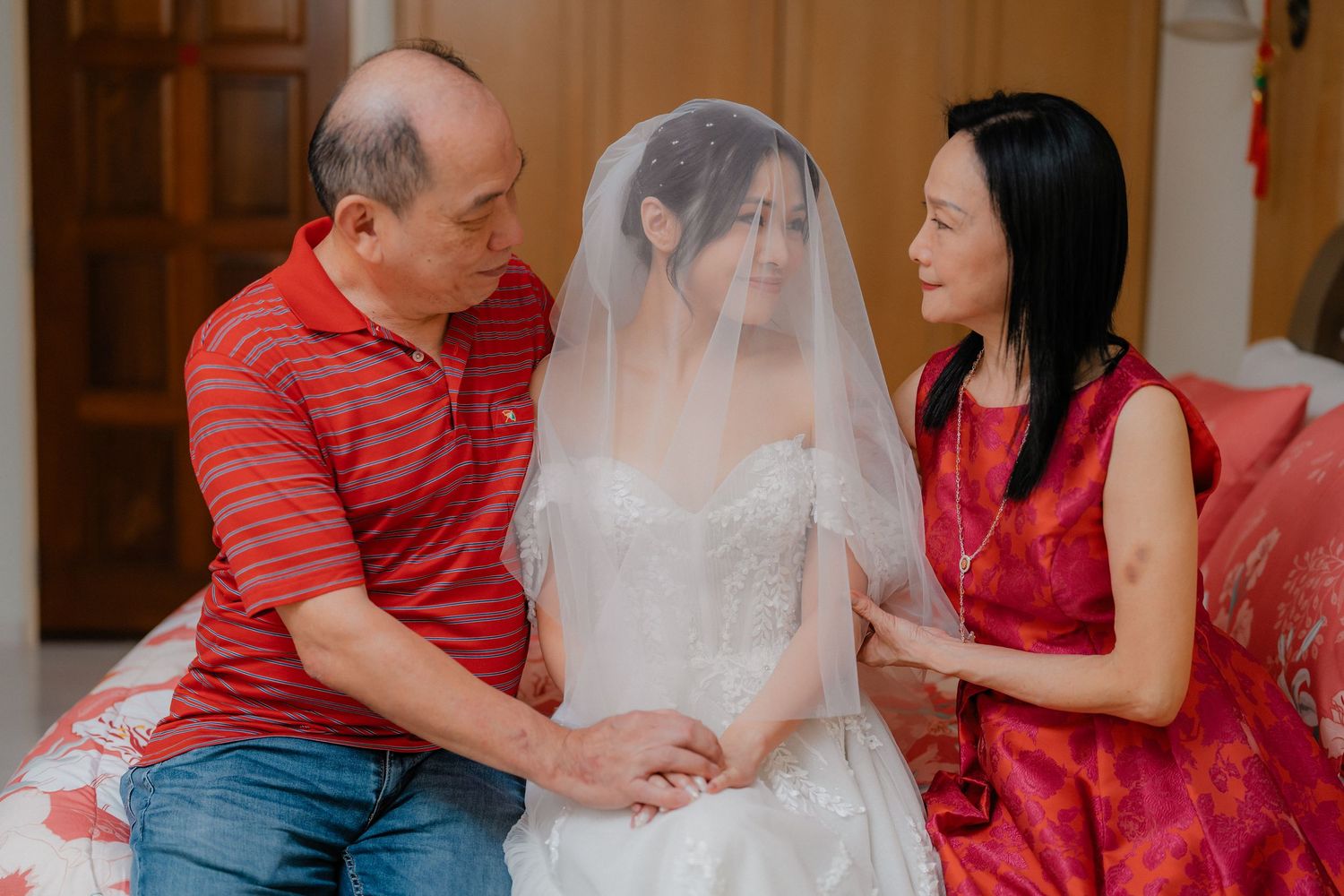 Wedding guests in festive red attire celebrate during an intimate ceremony moment.