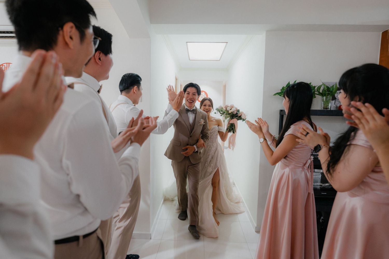Candid moments of a wedding party getting ready and celebrating together in a bright indoor venue.