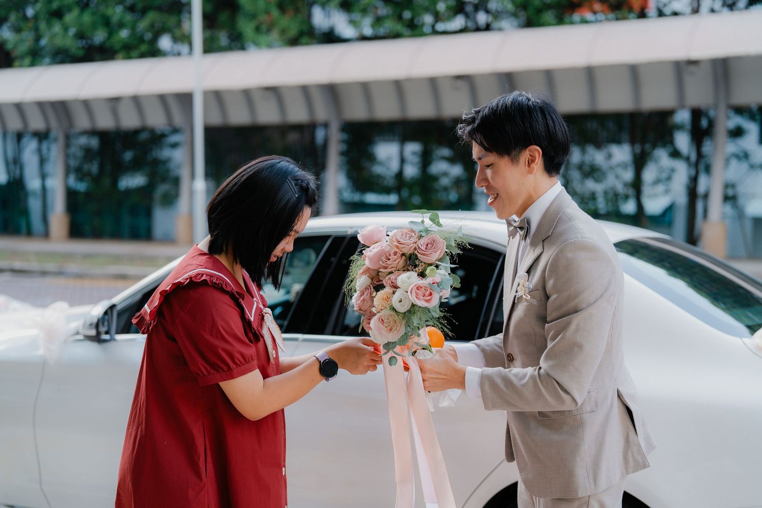 Wedding day moments captured outside with soft natural lighting.