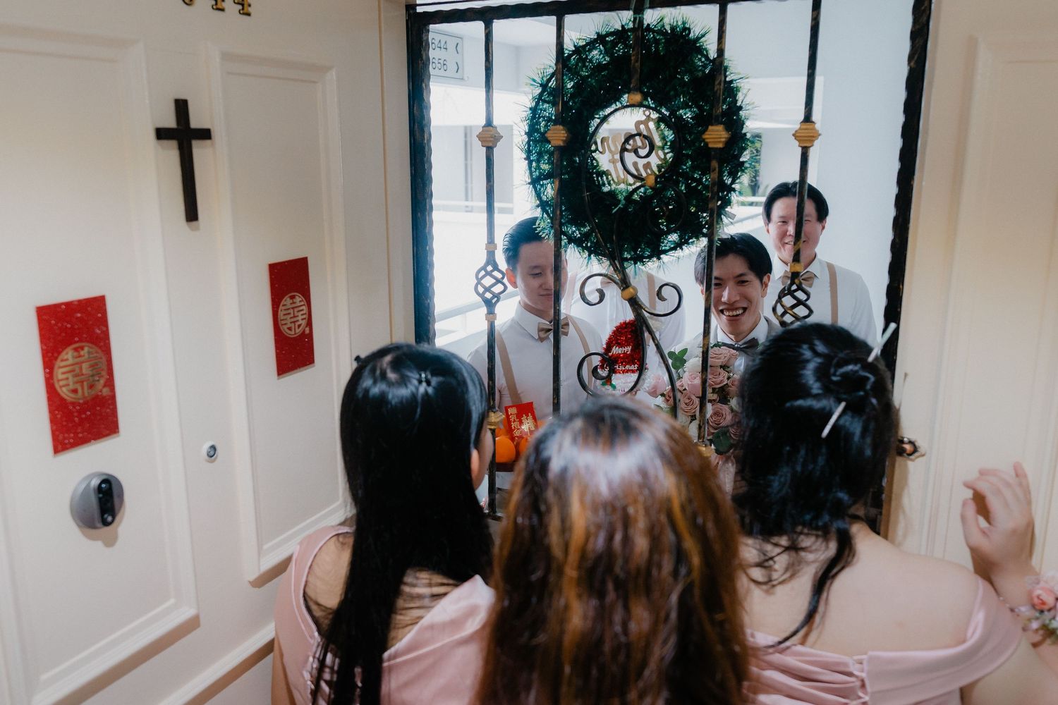 Church interior decorated for a wedding ceremony with holiday wreaths and crosses.