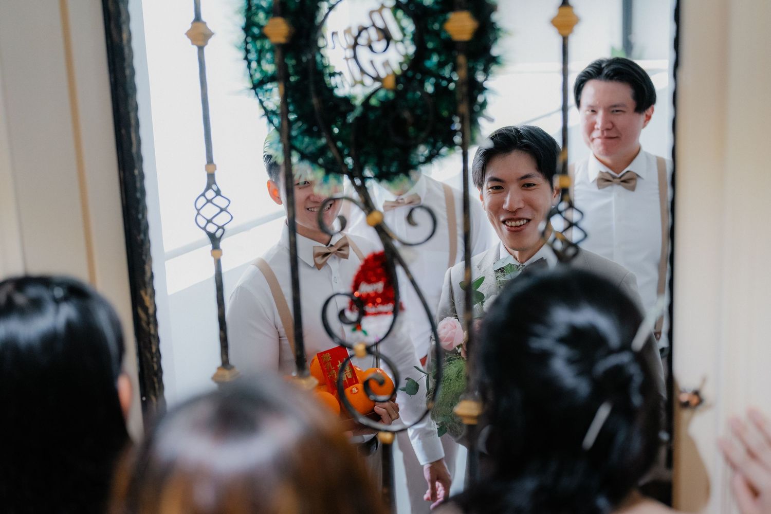 Decorative holiday wreaths and ornaments adorning an indoor venue entrance.