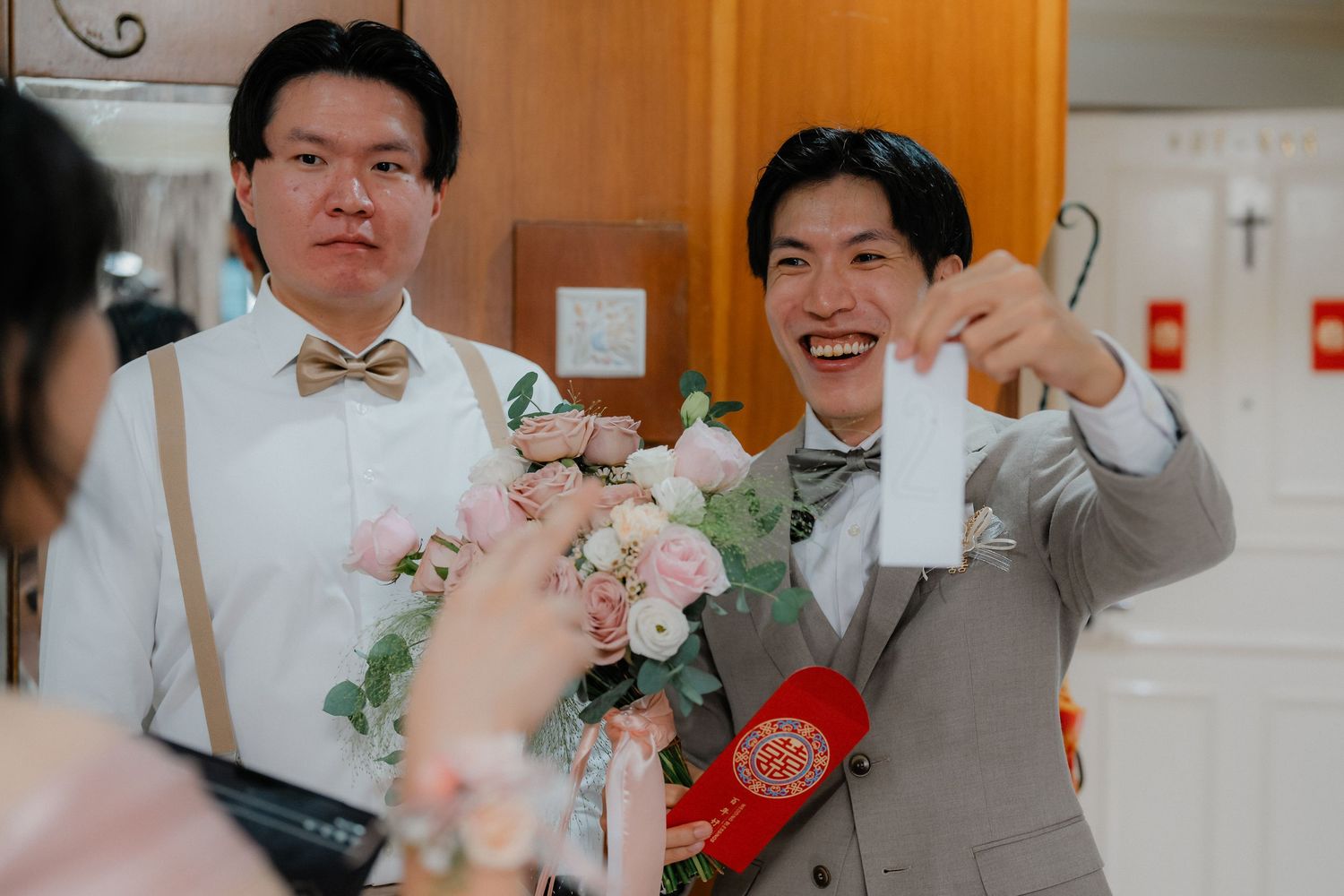 Wedding celebration moments captured with pink floral accents and warm lighting.