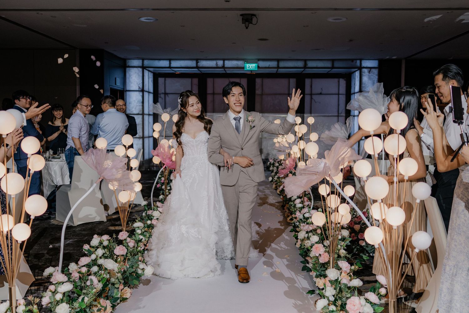 Elegant wedding reception space with glowing paper lanterns and floral decor.
