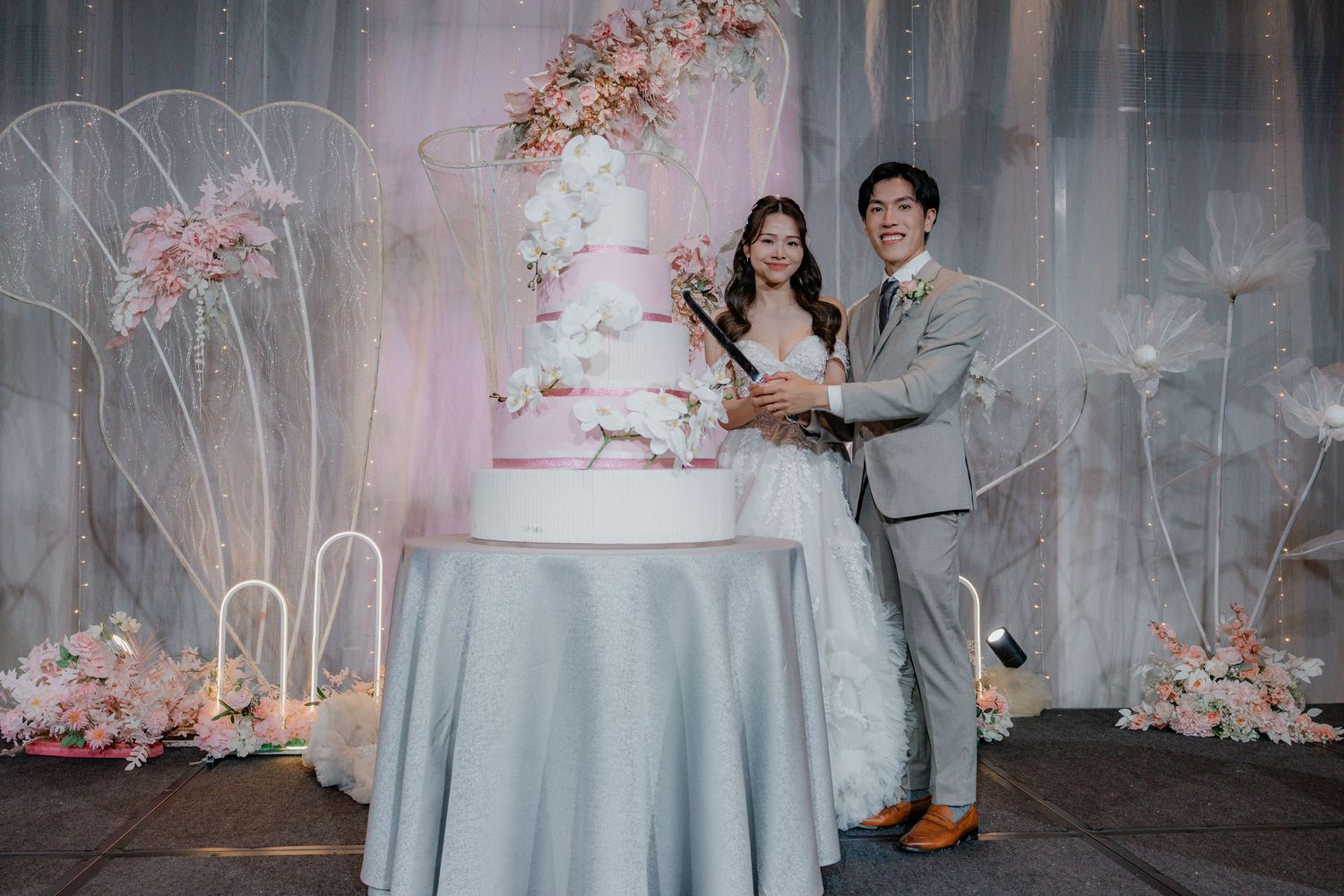 Collage of wedding photos showing elegant table settings with cherry blossoms and a tiered white wedding cake with floral decor.