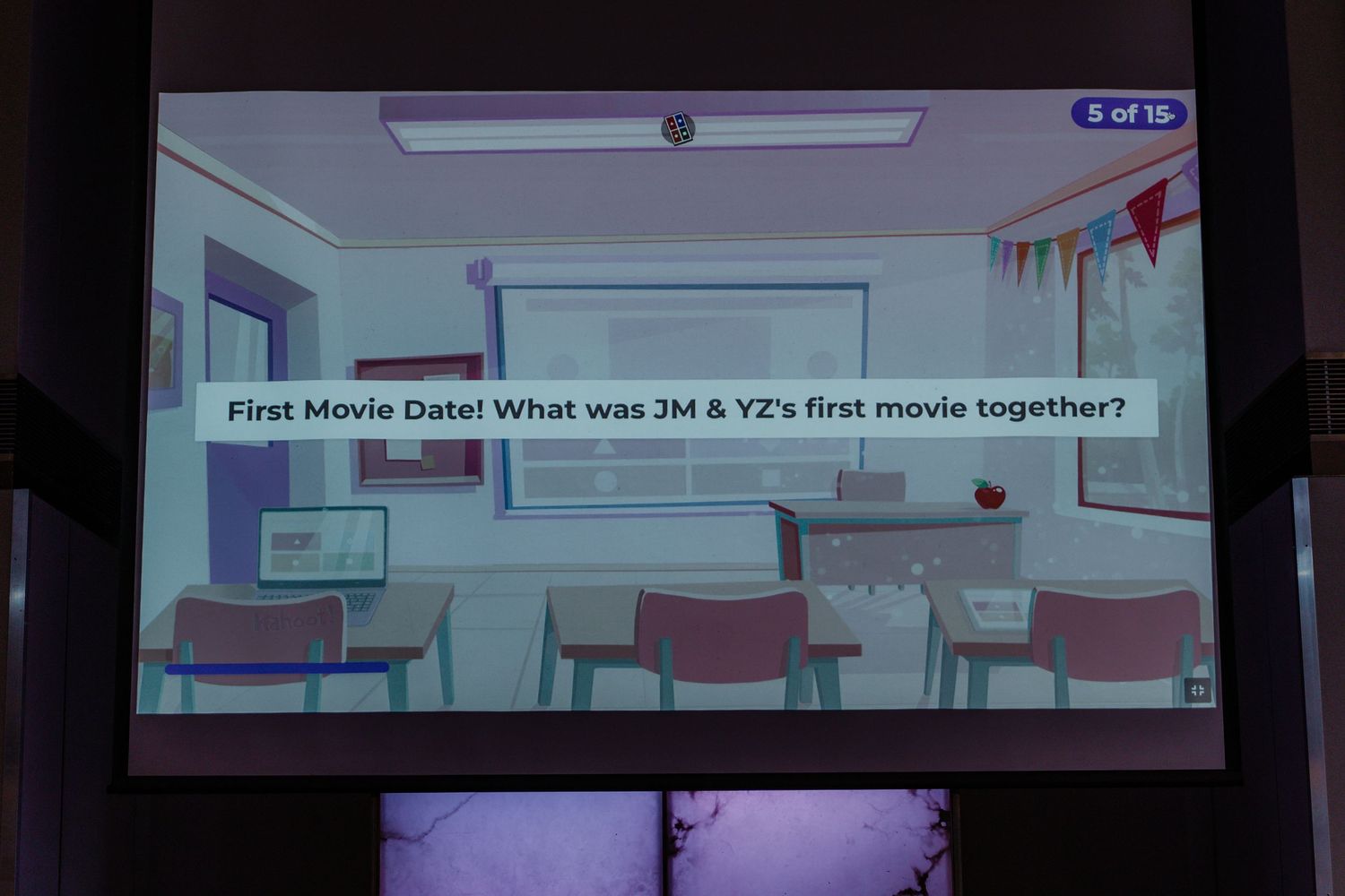 A projector screen displays a trivia question in a classroom-style setting.