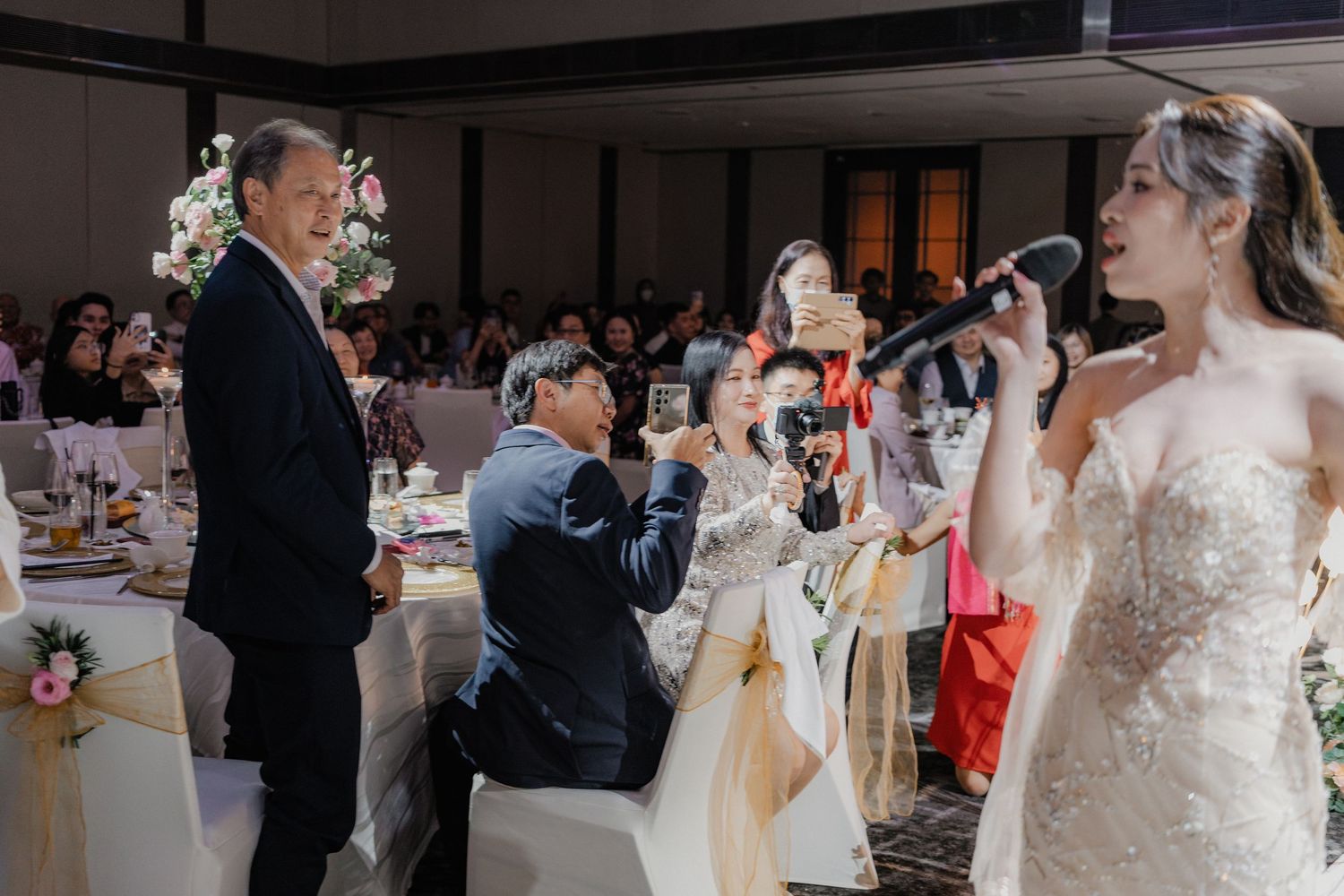 Wedding celebration with live music performance at an indoor reception venue.