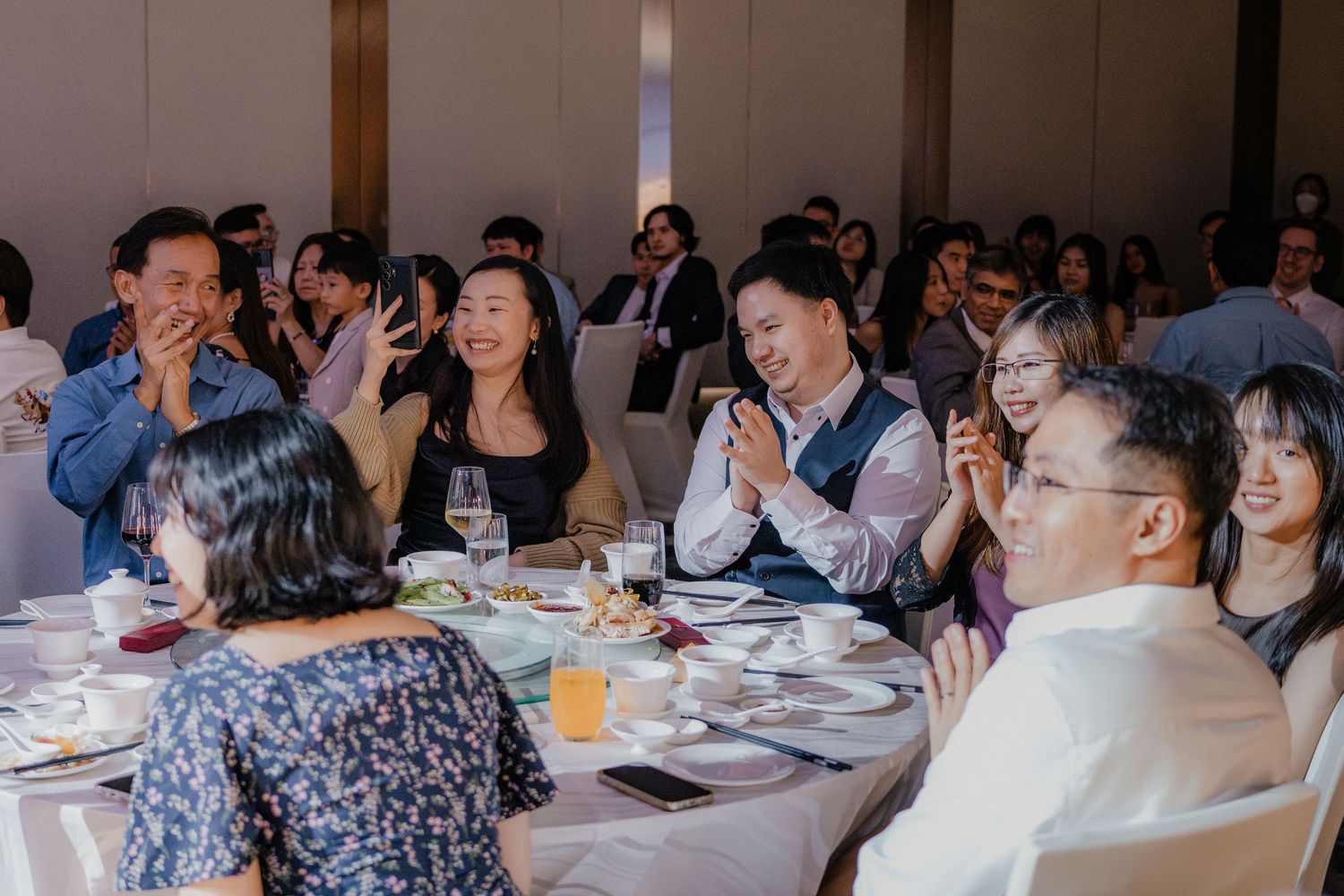 Wedding guests enjoying themselves and laughing during the reception dinner.