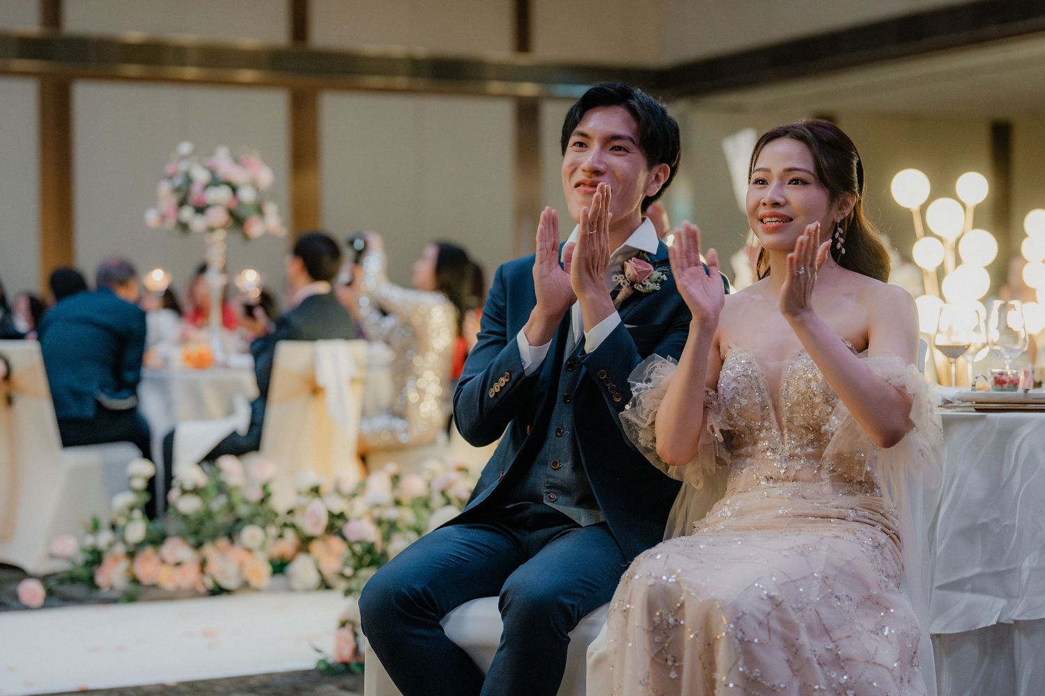 Wedding reception guests sharing emotional moments at an elegantly decorated venue.