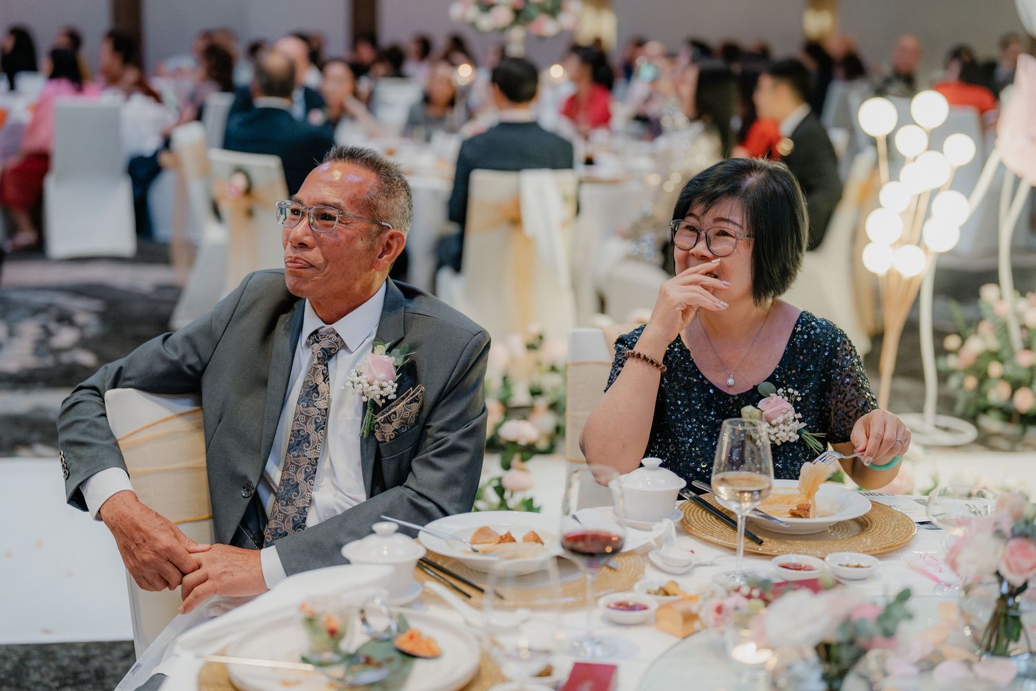 Senior couple enjoying their meal at an elegant wedding reception.