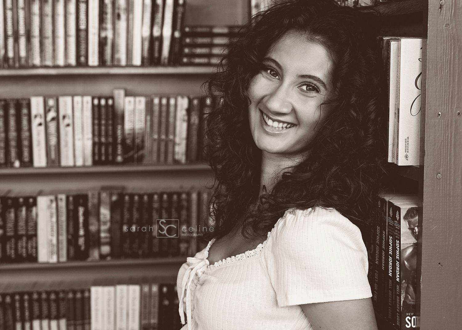 Vintage black and white headshot portraits of a woman with dark curly hair against a bookshelf background.