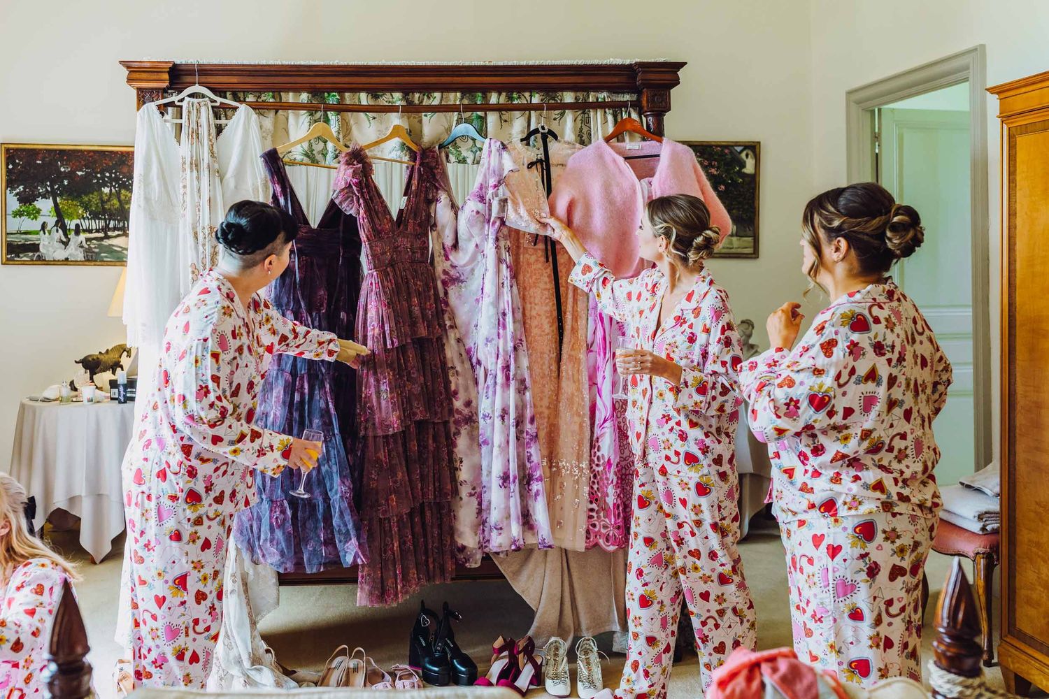 Retail clothing store showing floral print dresses and feminine fashions arranged on display racks.