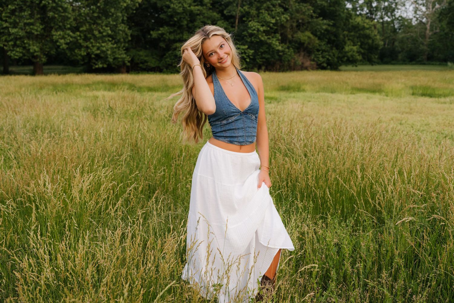 A series of outdoor portraits showing a figure in a white dress posing gracefully in a sunlit summer meadow with tall grass.