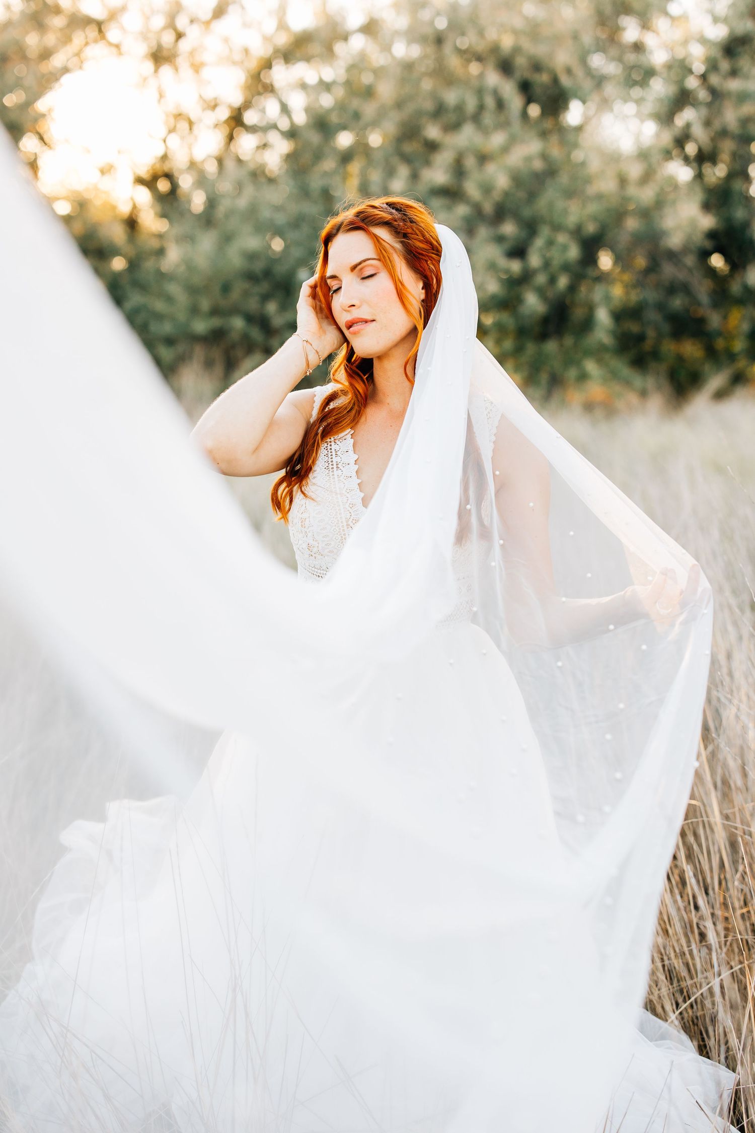 bridal images of a bride in a long veil with red hair at bountiful pondbridal images of a bride in a long veil with red