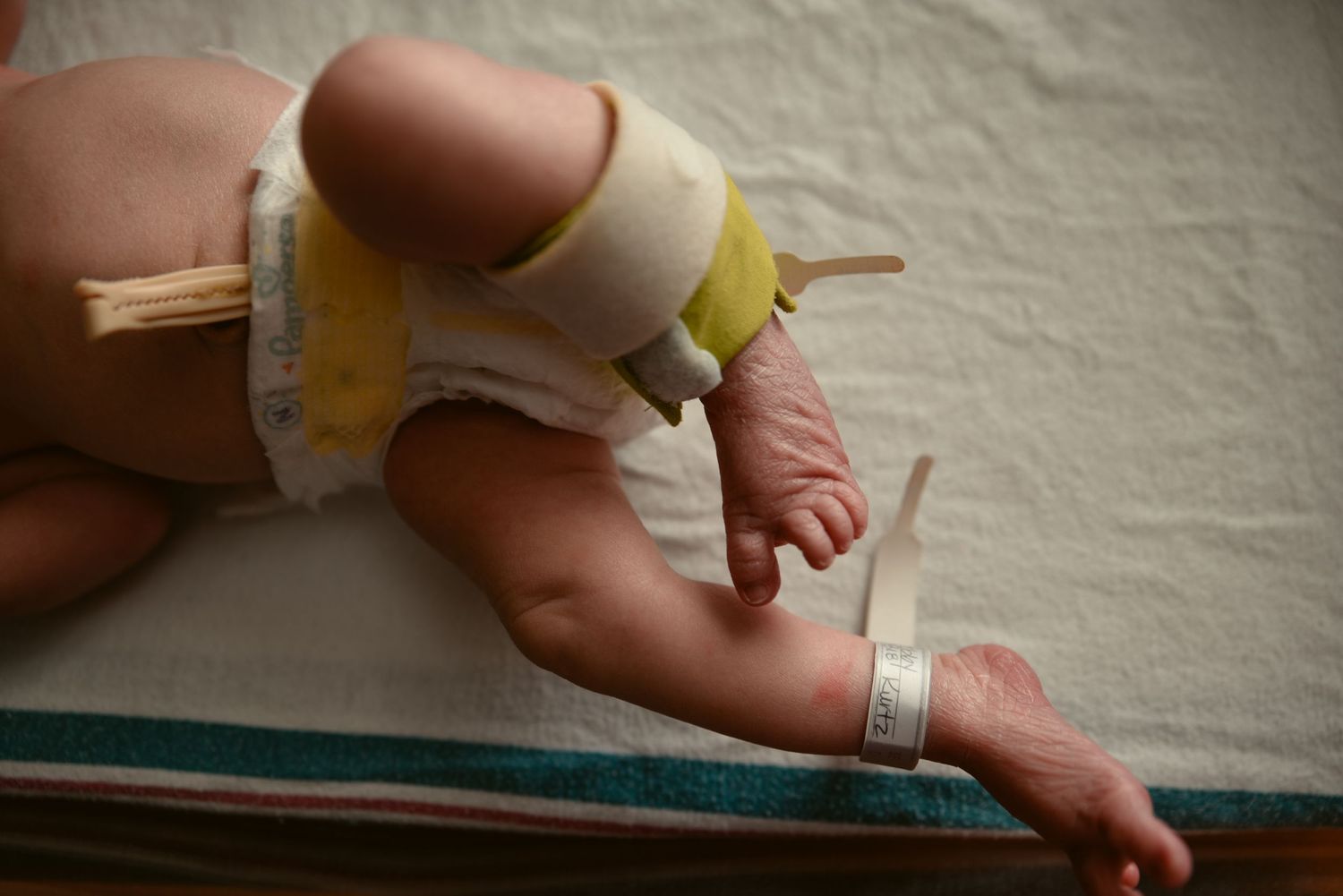 Close-up details of baby feet and hands during intimate photo session.