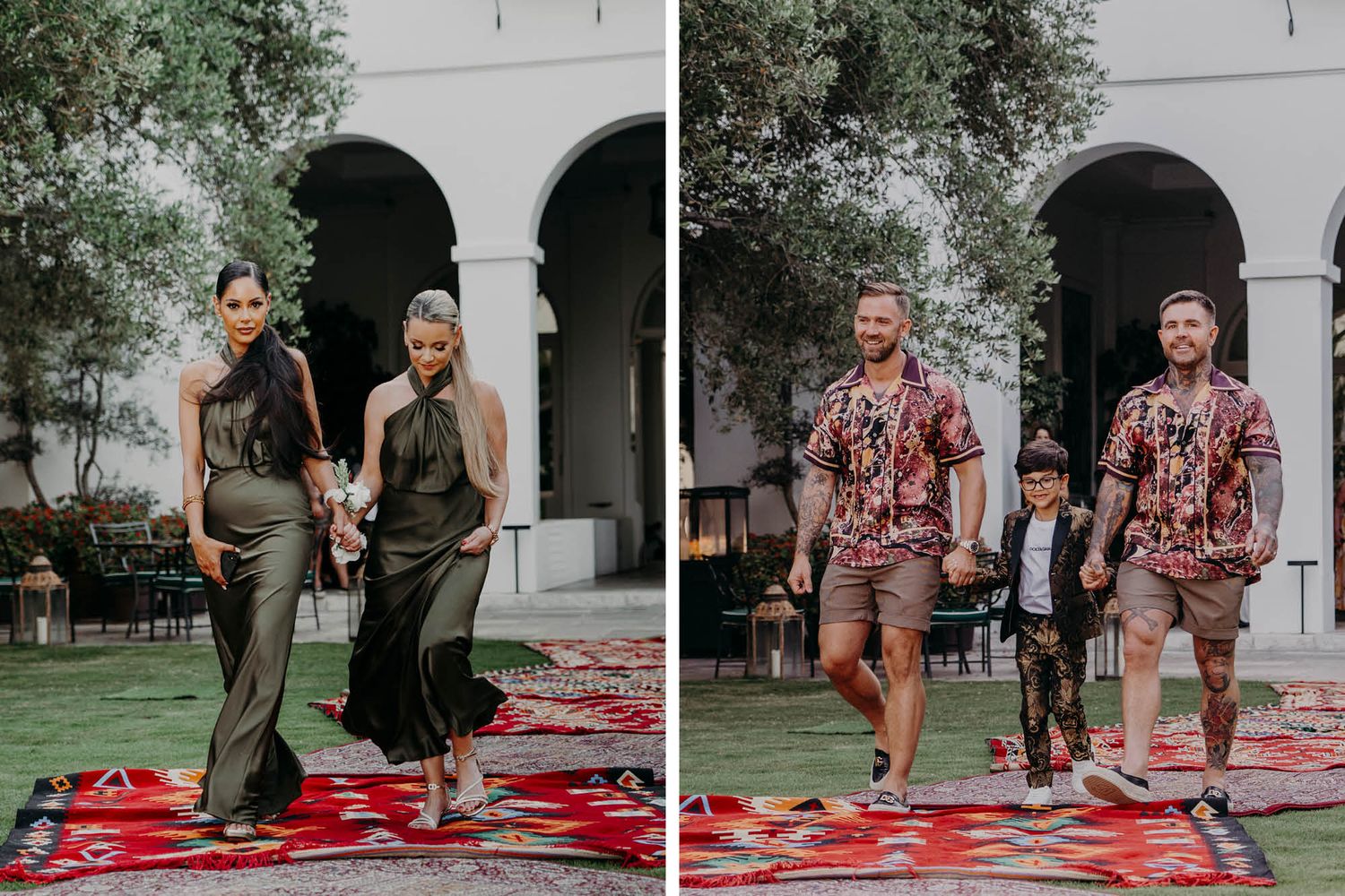 Two pairs of people walk down a red carpet walkway in front of an arched building with lush greenery.