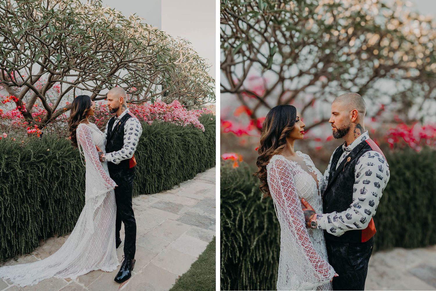 A romantic outdoor wedding photo showing a couple in front of blooming pink bushes and twisted trees.