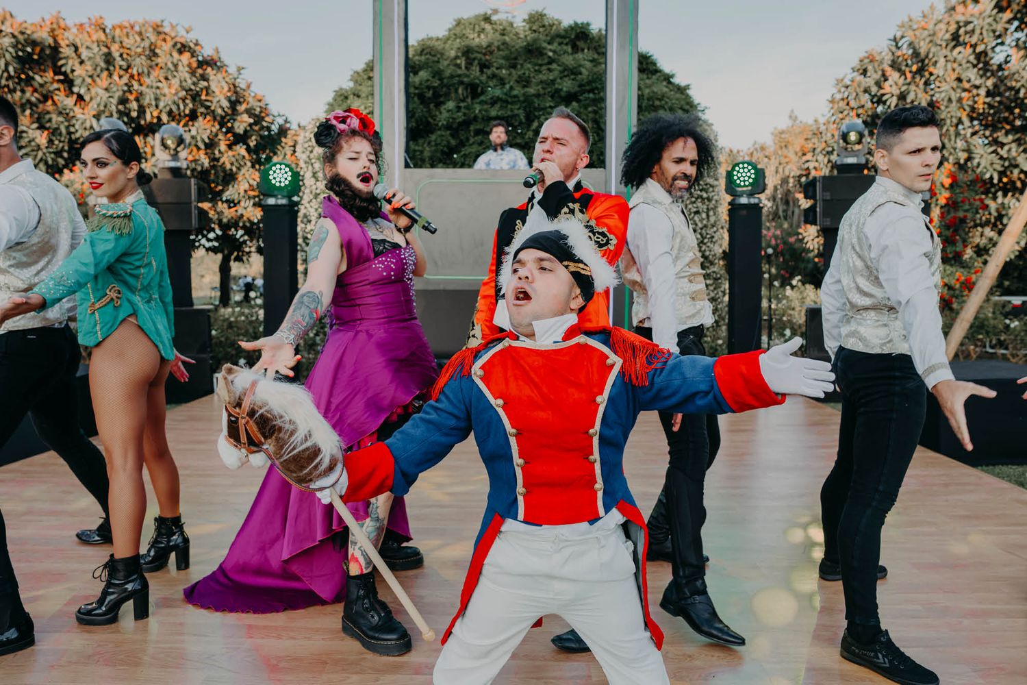 Festive group dancing together in colorful outfits during a lively celebration.