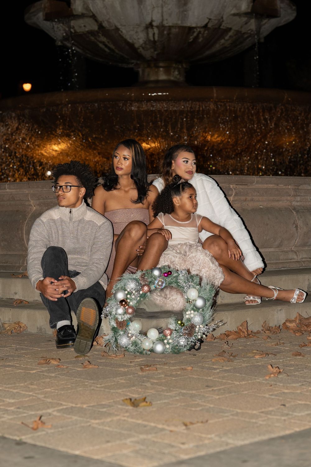 A group sits on a stone patio at night with floral decorations and formal attire visible in a candid photo series.