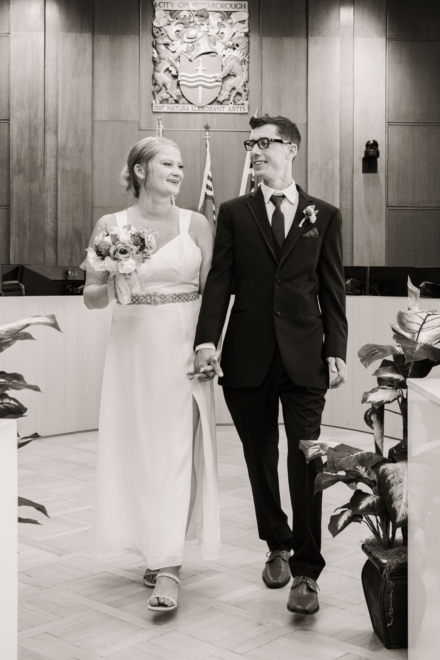 A wedding ceremony in a courthouse with a black and white photo of a couple walking together.