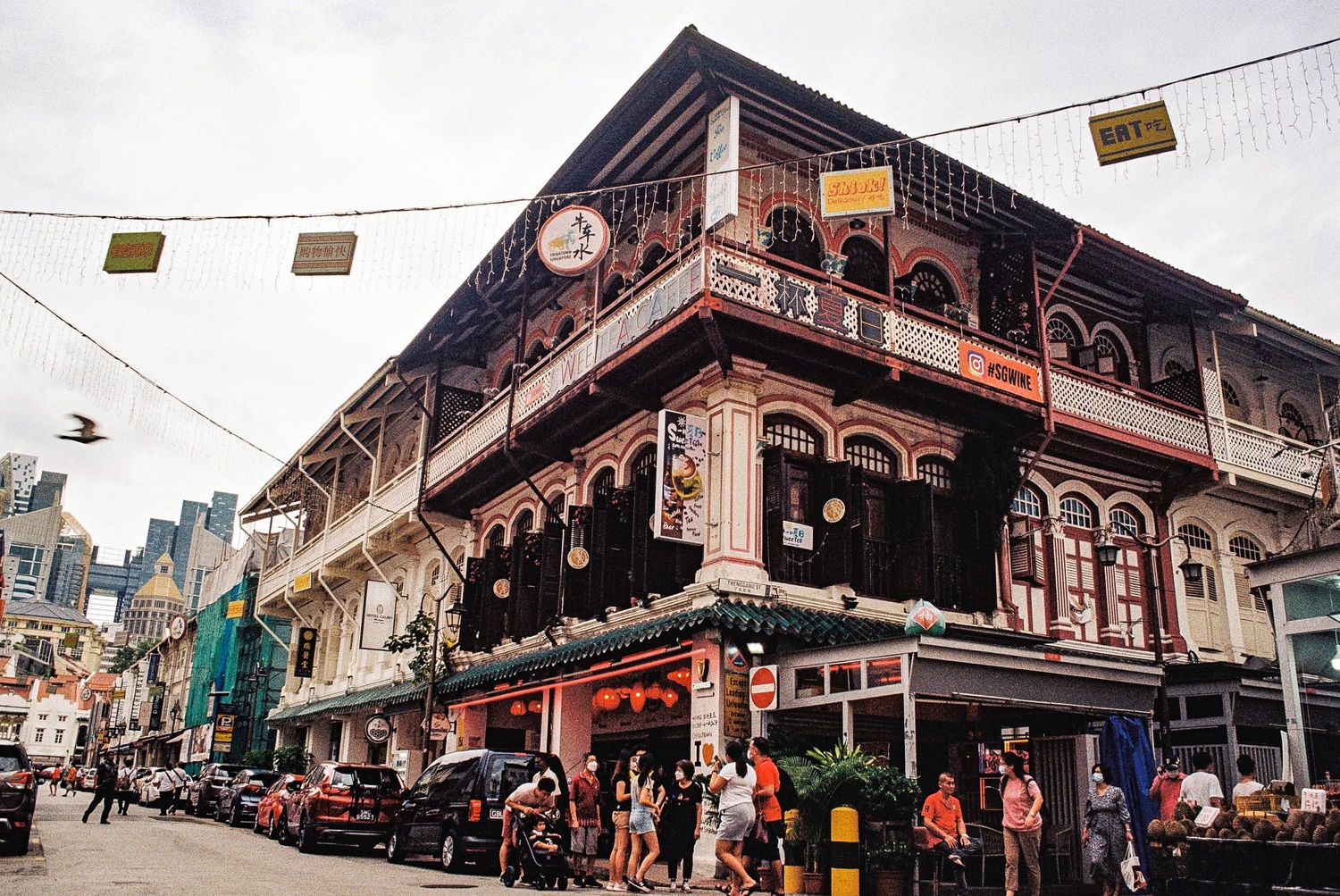 Historic Victorian-style building with ornate balconies and commercial storefronts in San Francisco's Chinatown district.