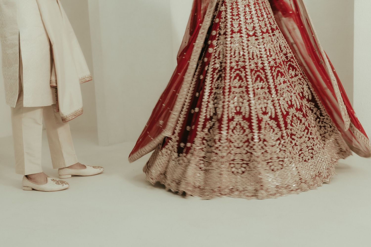 A tender wedding moment captured through a delicate veil in a garden setting.