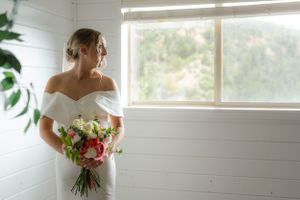Bright sunlit room with white walls and large windows creating a natural glow.
