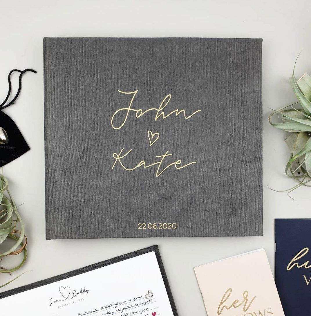 Custom photo album featuring the bride and groom’s names, preserving special moments with photo booth prints from their wedding day.