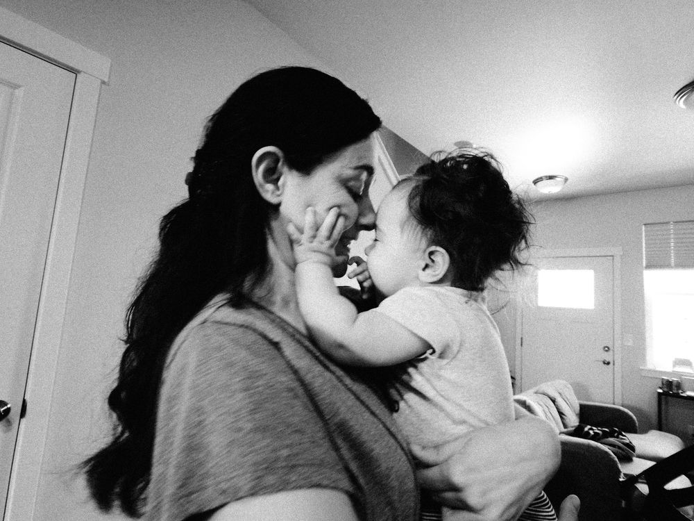 A series of black and white photographs showing a couple in an intimate embrace and kiss sequence.
