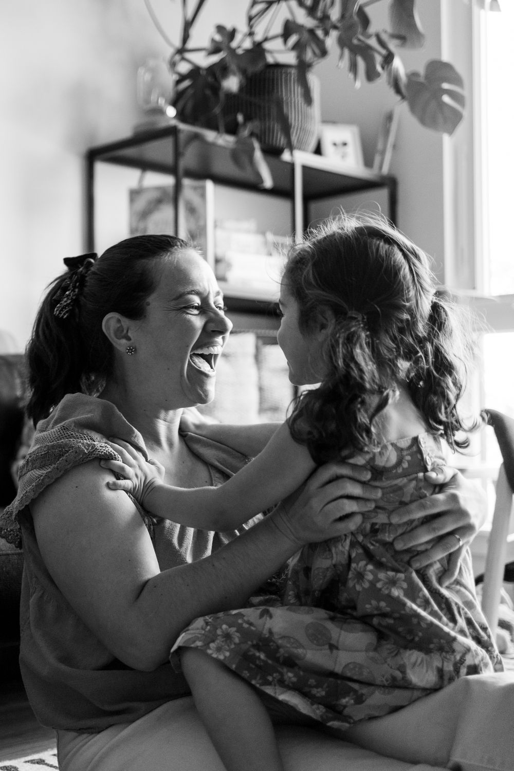 A series of black and white photos showing a tender moment between two people embracing in an emotional sequence.