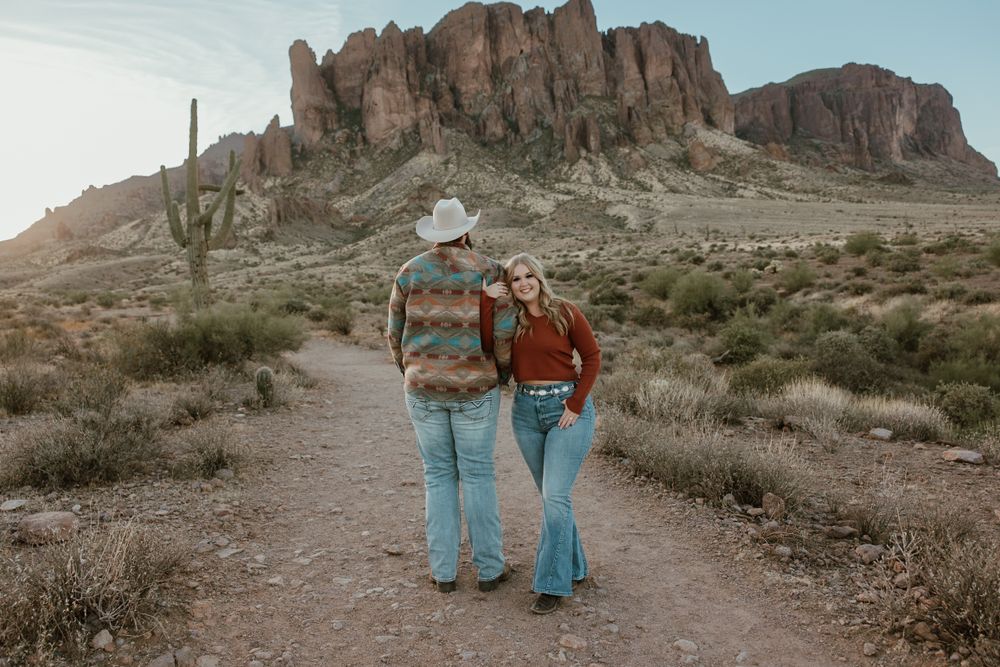 Grasping her partners arm while he enjoys the view of the Superstition mountains.