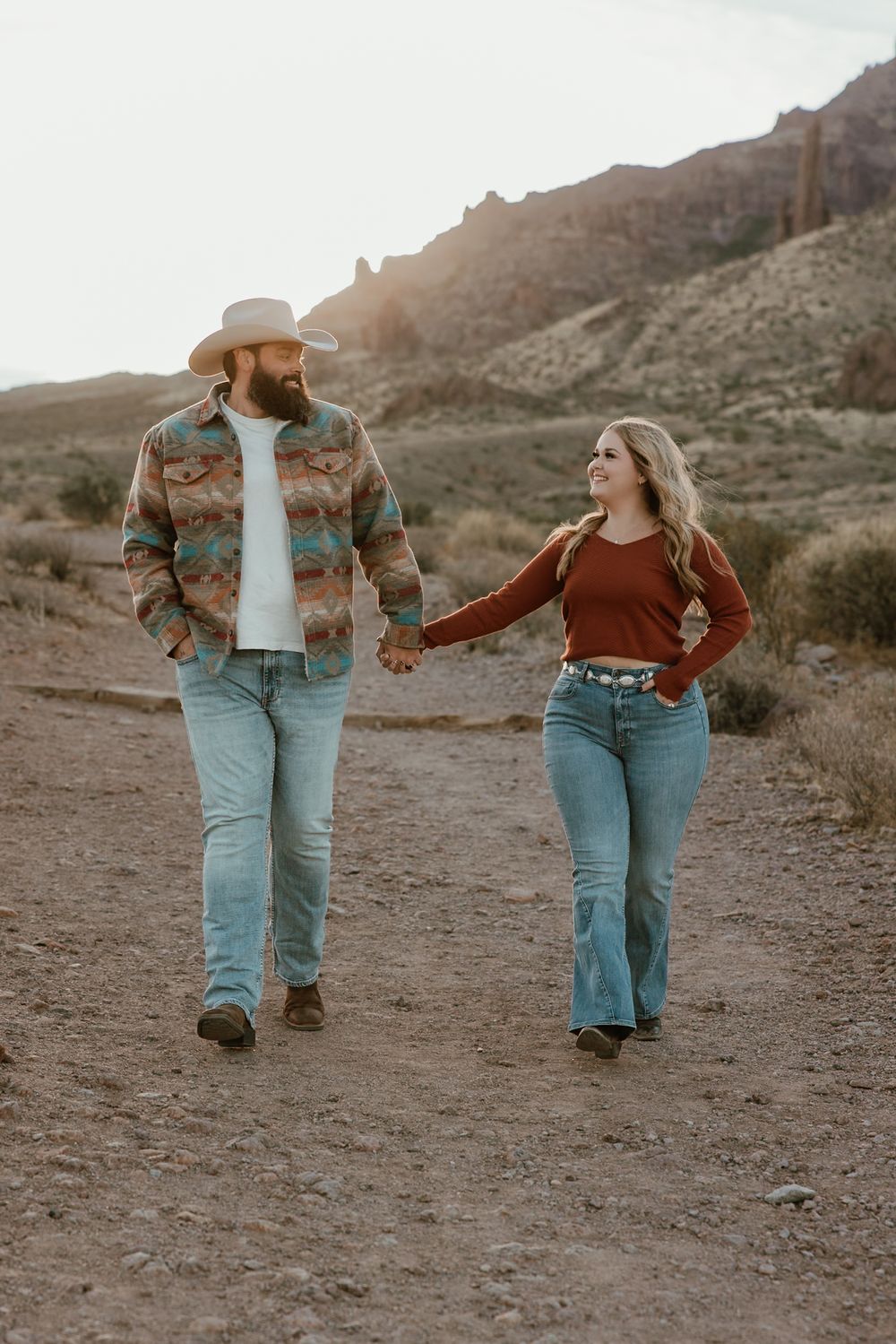 A couple walking down a path in Apache Junction Arizona.