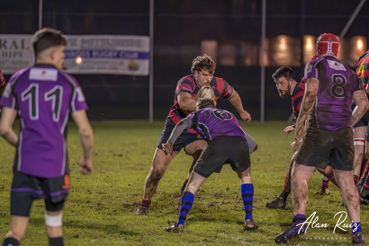 Rugby players in action during a competitive match on a sports field.