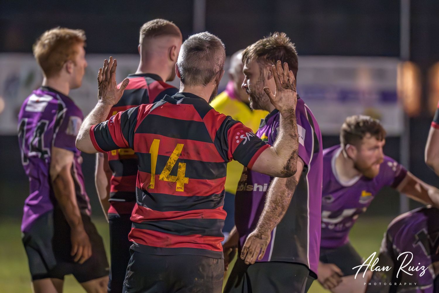 Rugby players from both teams battle for possession during a competitive match.