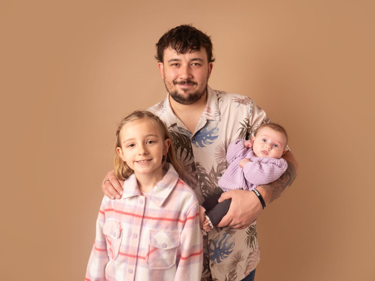dad with his two daughters holding his baby for family photoshoot in Doncaster