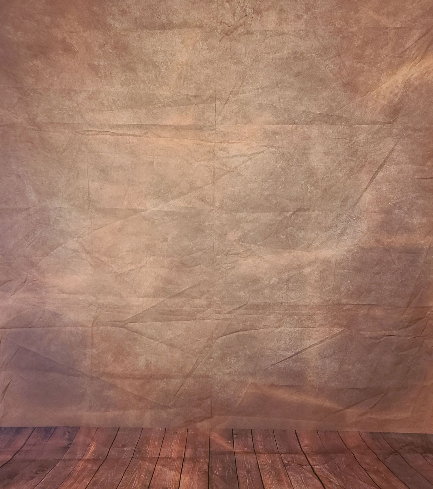 Brown aged photography backdrop with wooden floor and textured wall.